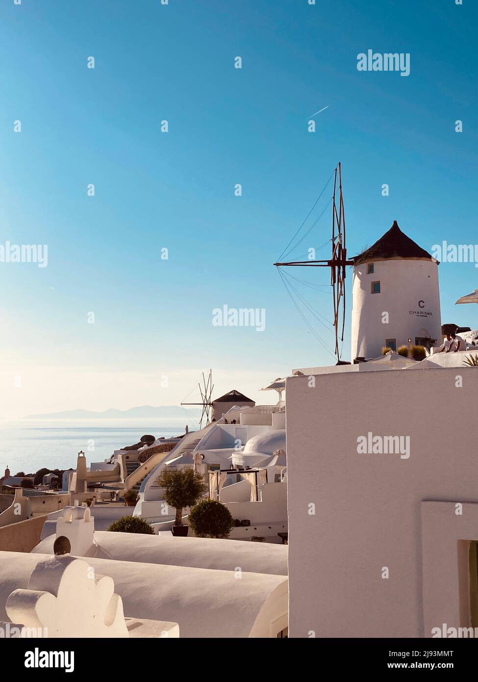 A windmill overlooking the sea on the greek island of Santorini Stock Photo