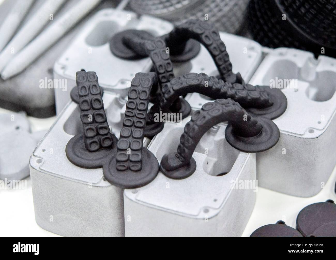 Different objects printed on 3D printer from powder polyamide. Models printed on industrial 3D printer. Modern new prototyping technology. Additive automation manufacturing 3D printing technology Stock Photo