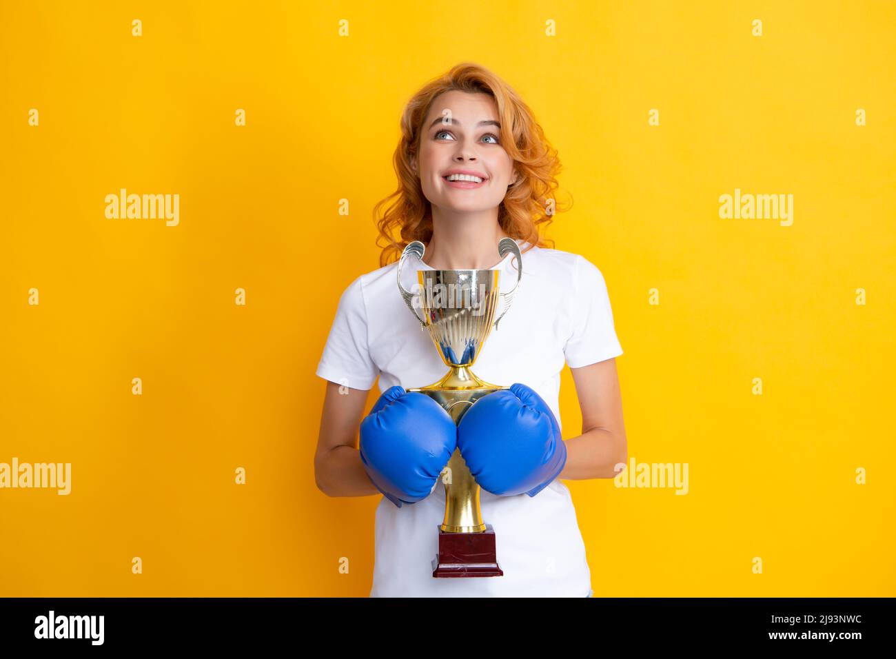 Cheerful woman celebrating victory. Woman in boxing gloves hold