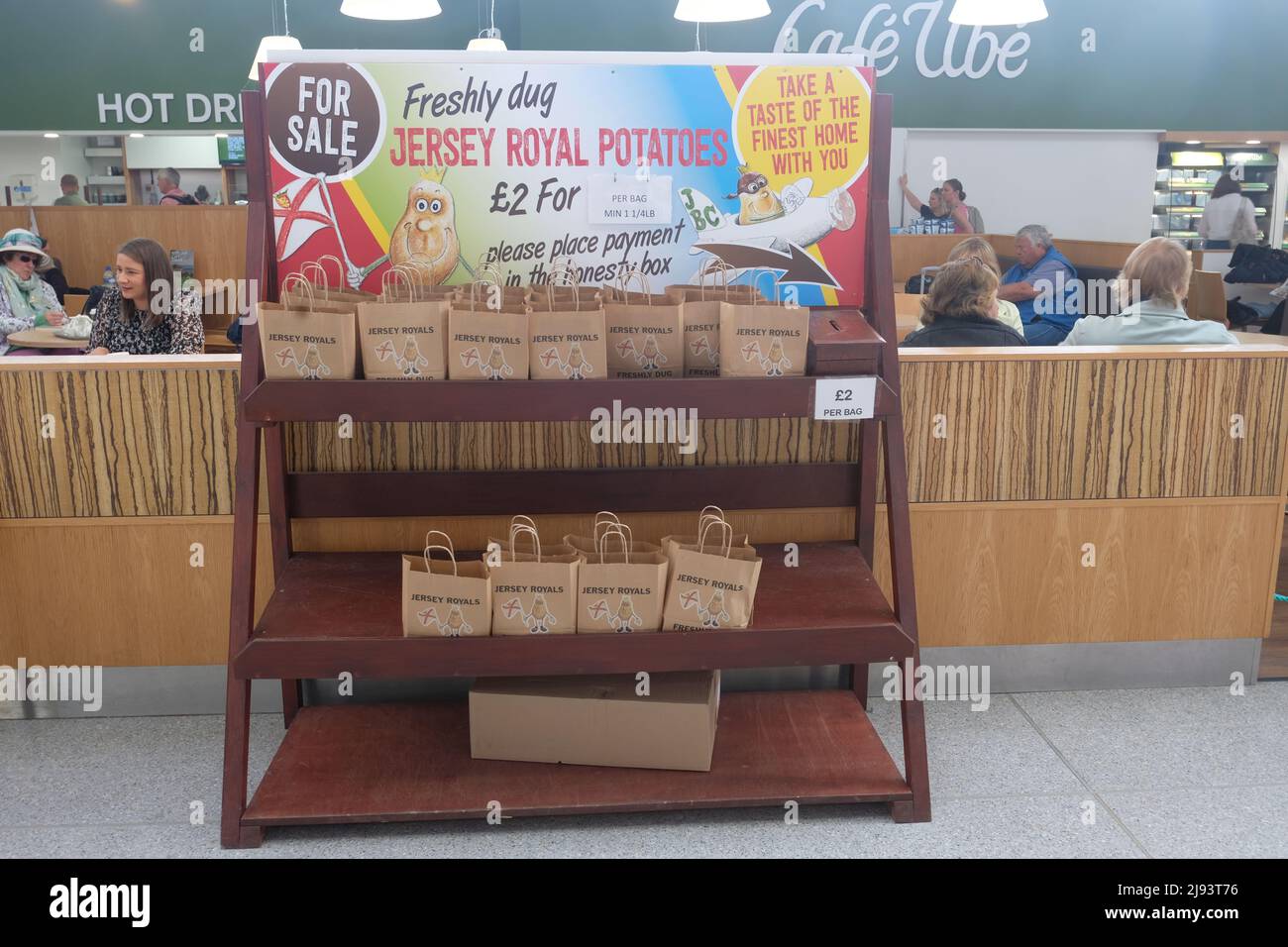 An unstaffed honesty box stand selling Jersey Royal potatoes inside Jersey  Airport Stock Photo - Alamy