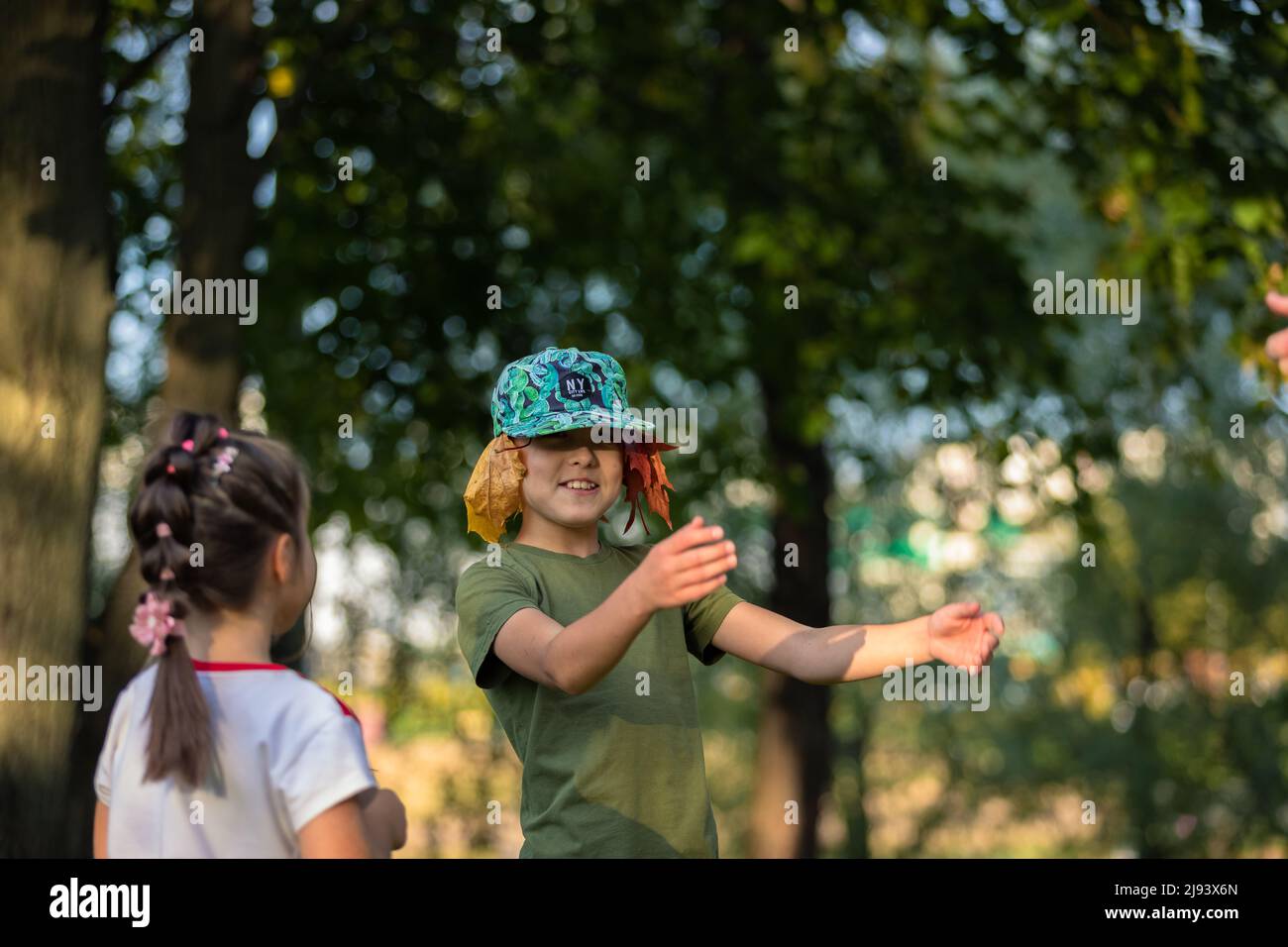 Brother and sister play and laugh in the park in summer. Russia Moscow September 24, 2020 Stock Photo