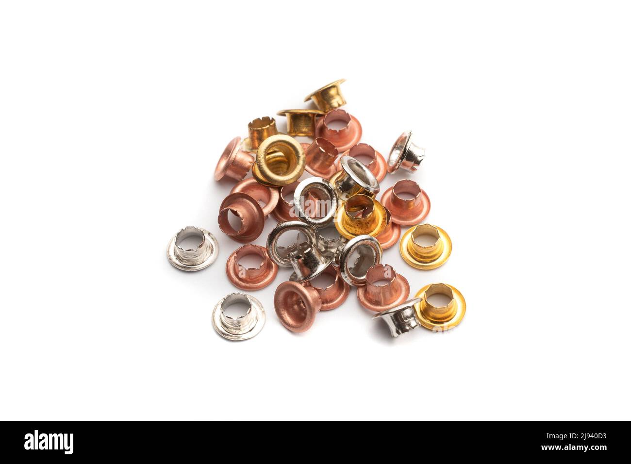 Eyelets in copper, gold and silver colored metal on a white background Stock Photo