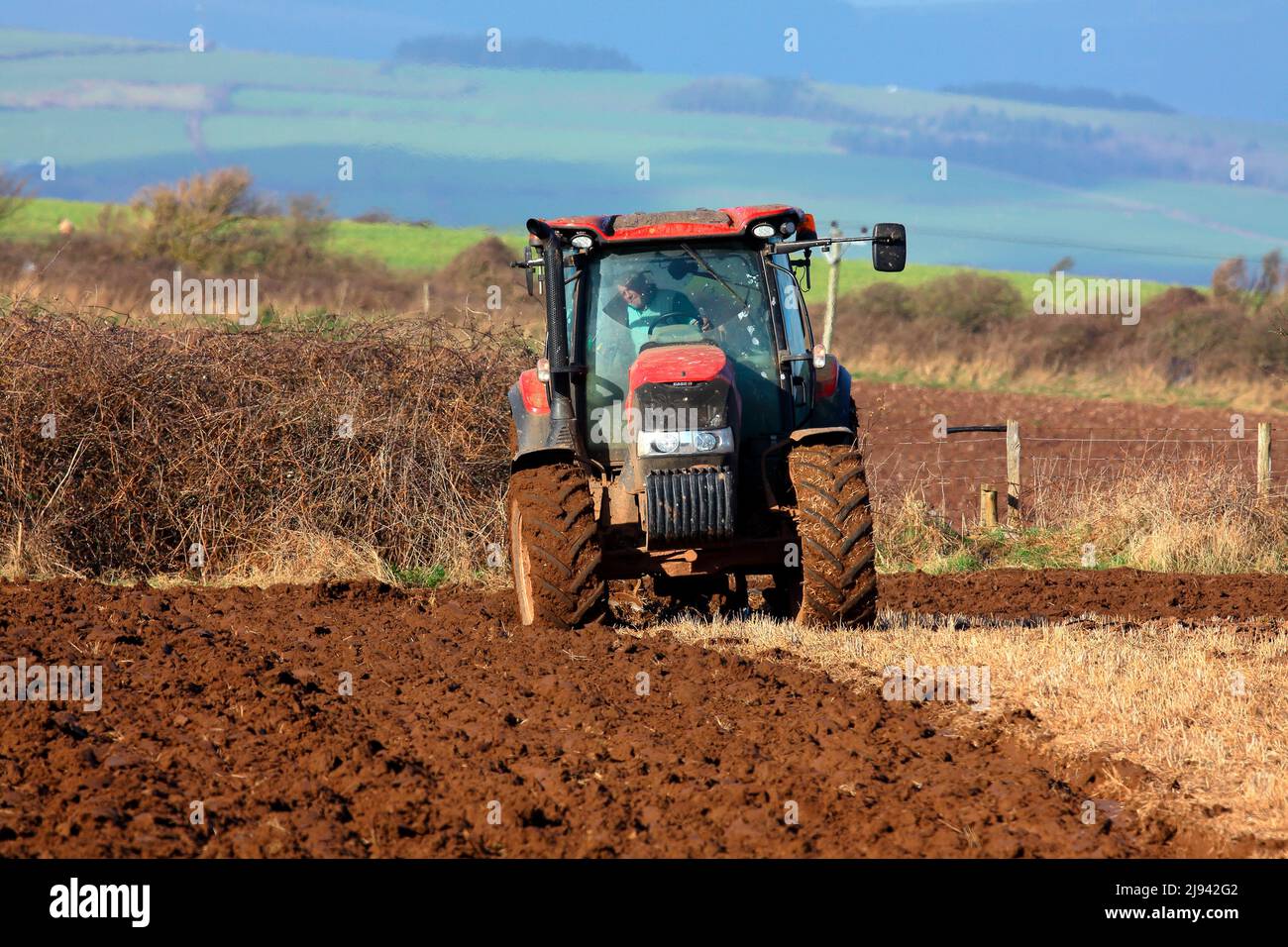 Field preparation for the next crop with the field being ploughed using