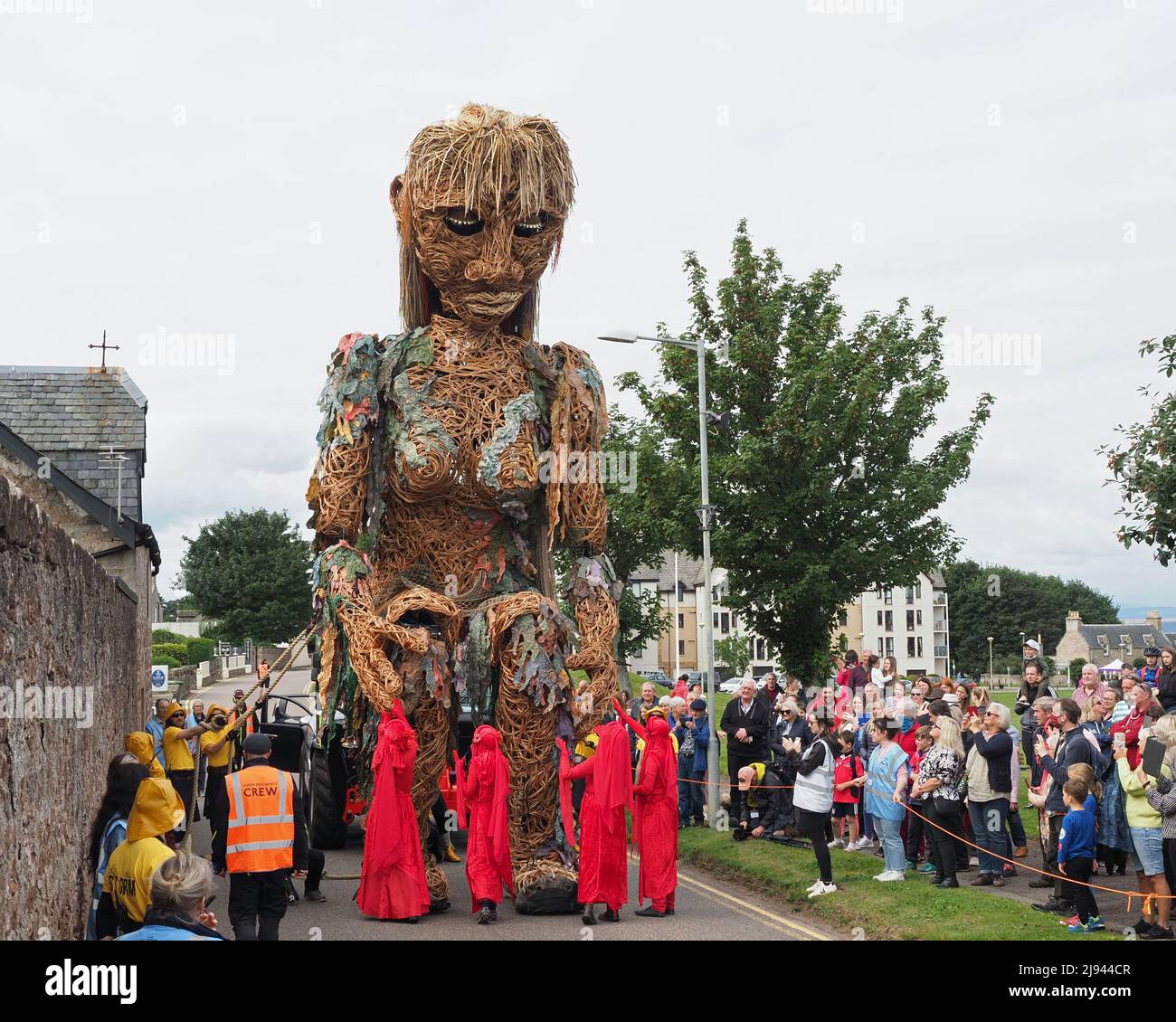 Storm, the mythical sea goddess bending down to meet the red spirits amongst the people near Nairn Links on an overcast day. Stock Photo