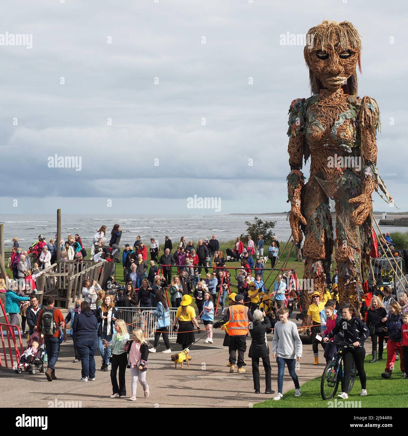 Storm, the mythical sea goddess walking amongst people at Nairn Links. She is a 10 metre tall mechanical puppet created by Vision Mechanics. Stock Photo