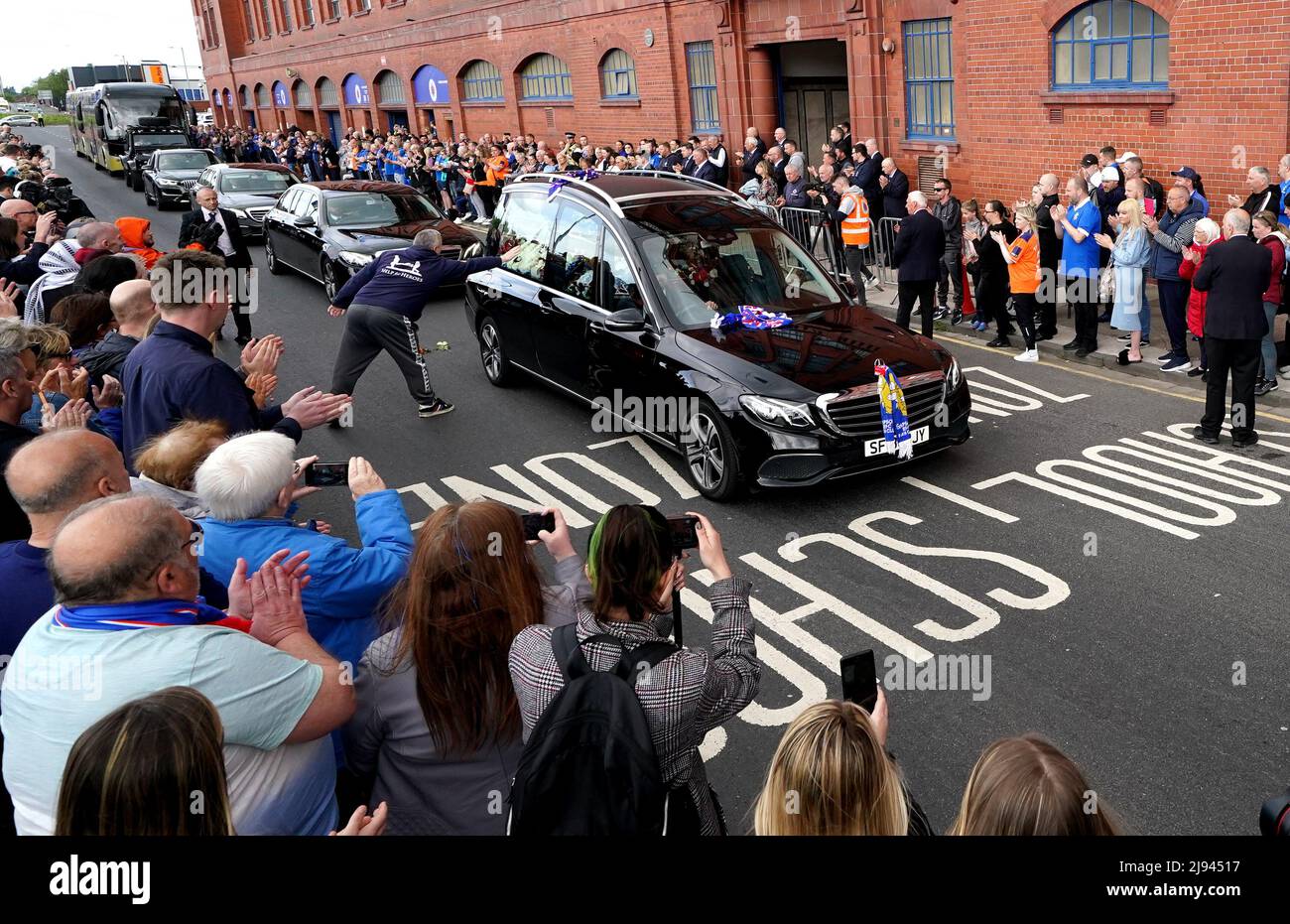 The funeral procession makes it's way past the Ibrox Stadium following
