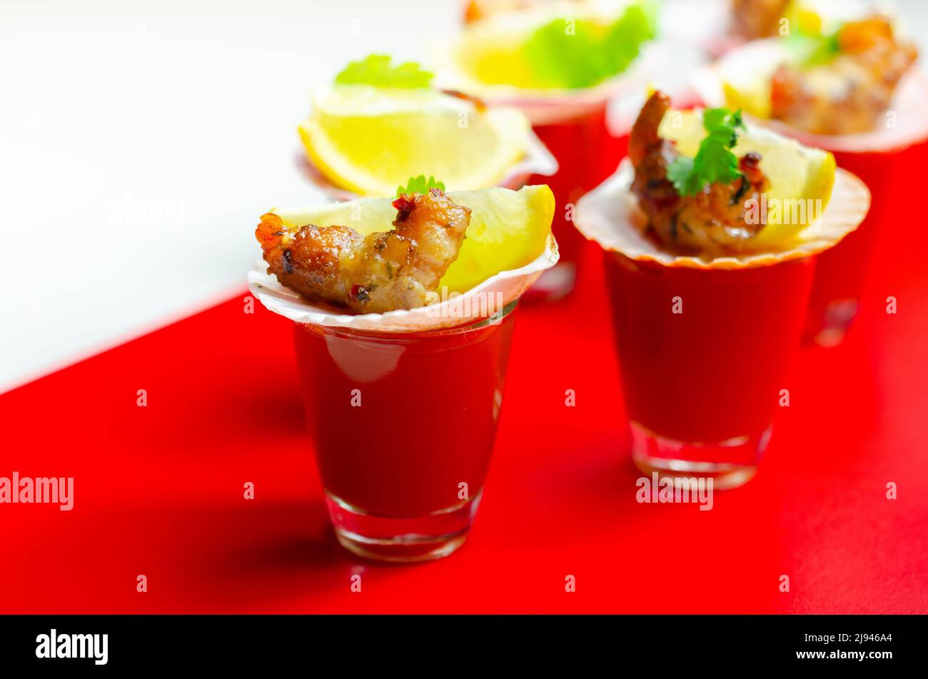 Bloody Mary cocktails in the shots drink served with prawns in blankets