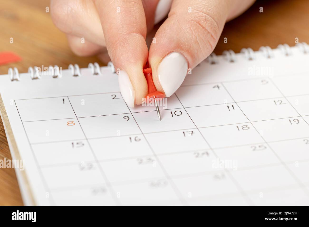red Hand pin stuck on the day of the month in the calendar, business