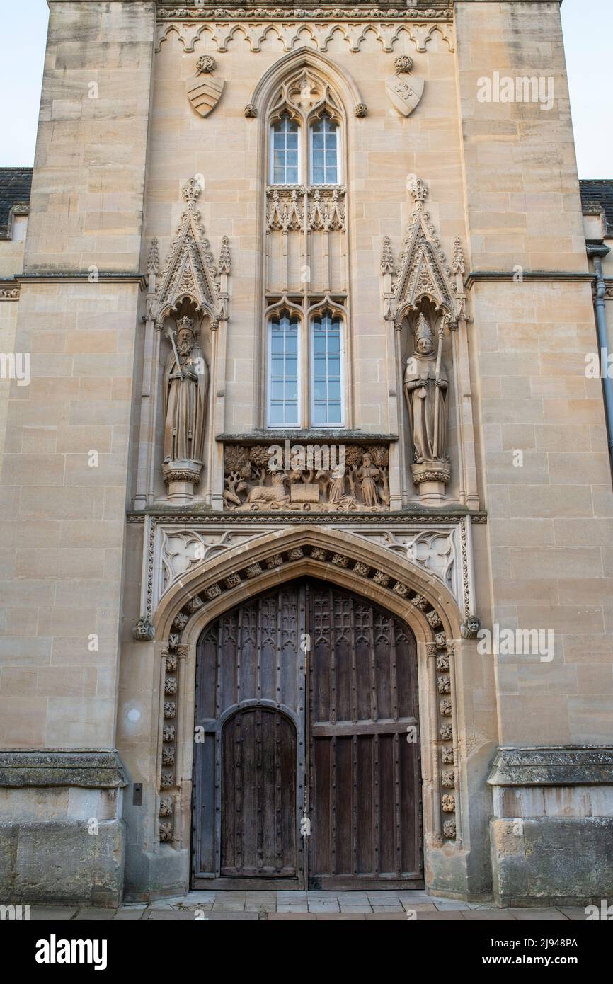 St john the baptist stone panel, Walter de Merton and Henry III stone sculpture above the wooden doors to Merton College, Oxford University, England Stock Photo