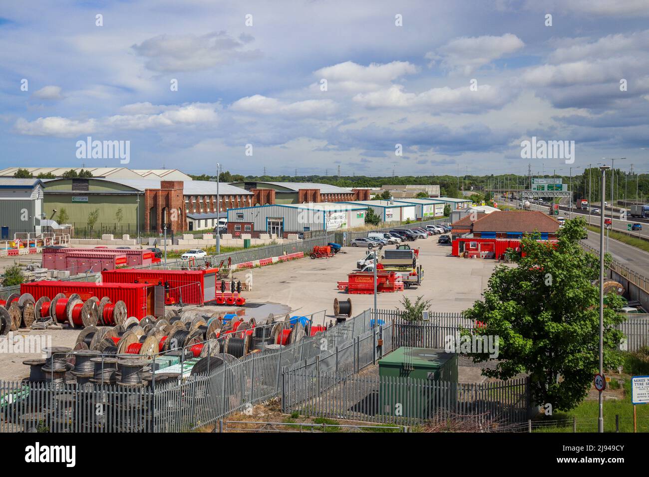 Industrial yard / estate with containers, wire cable reels / drums in red Stock Photo