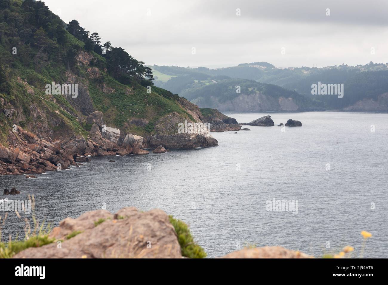 Calm waters of Bay of Biscay and sheer cliffs of its coast, covered