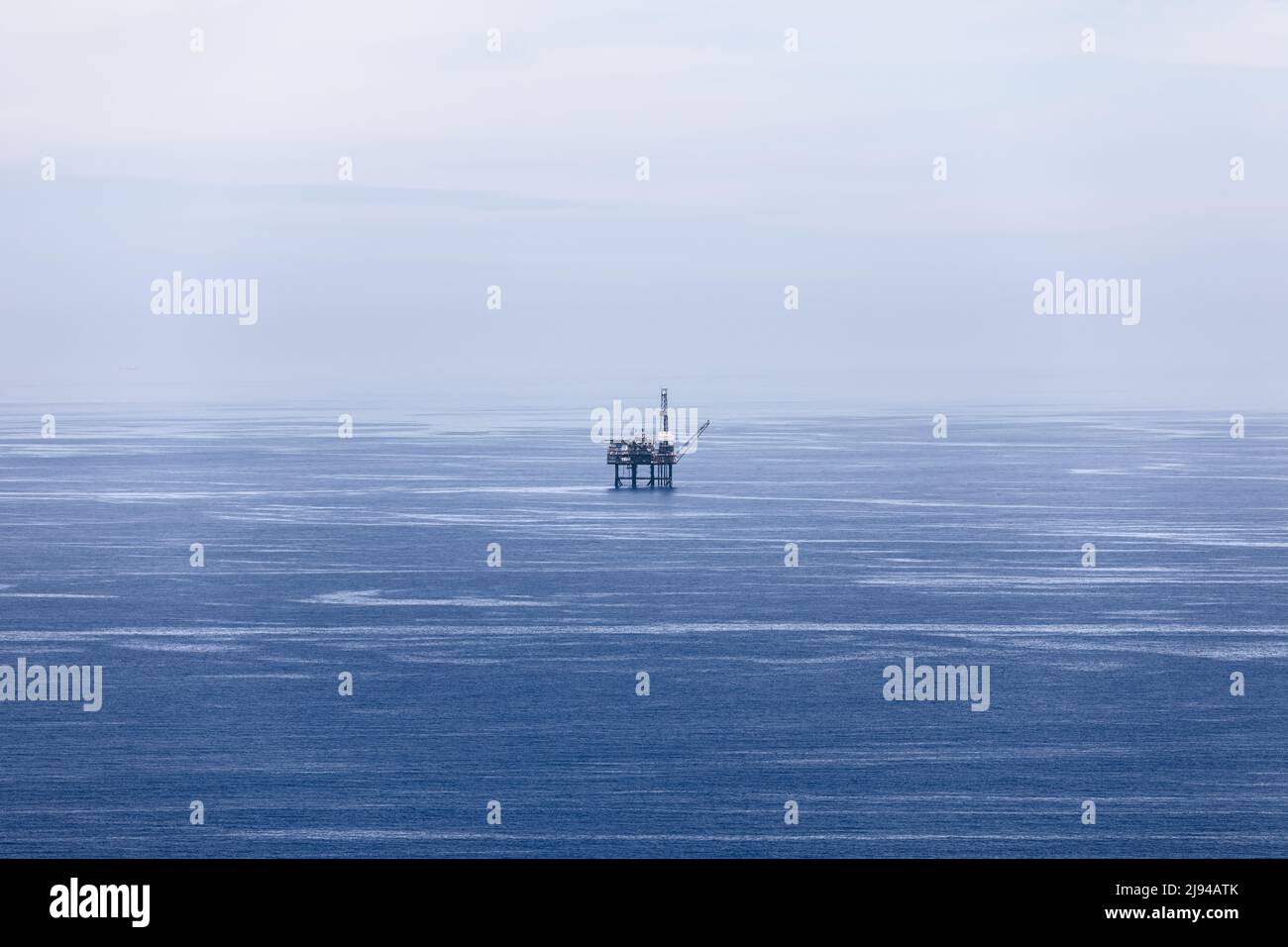 Blue waters of Bay of Biscay, covered with light ripples, merge with
