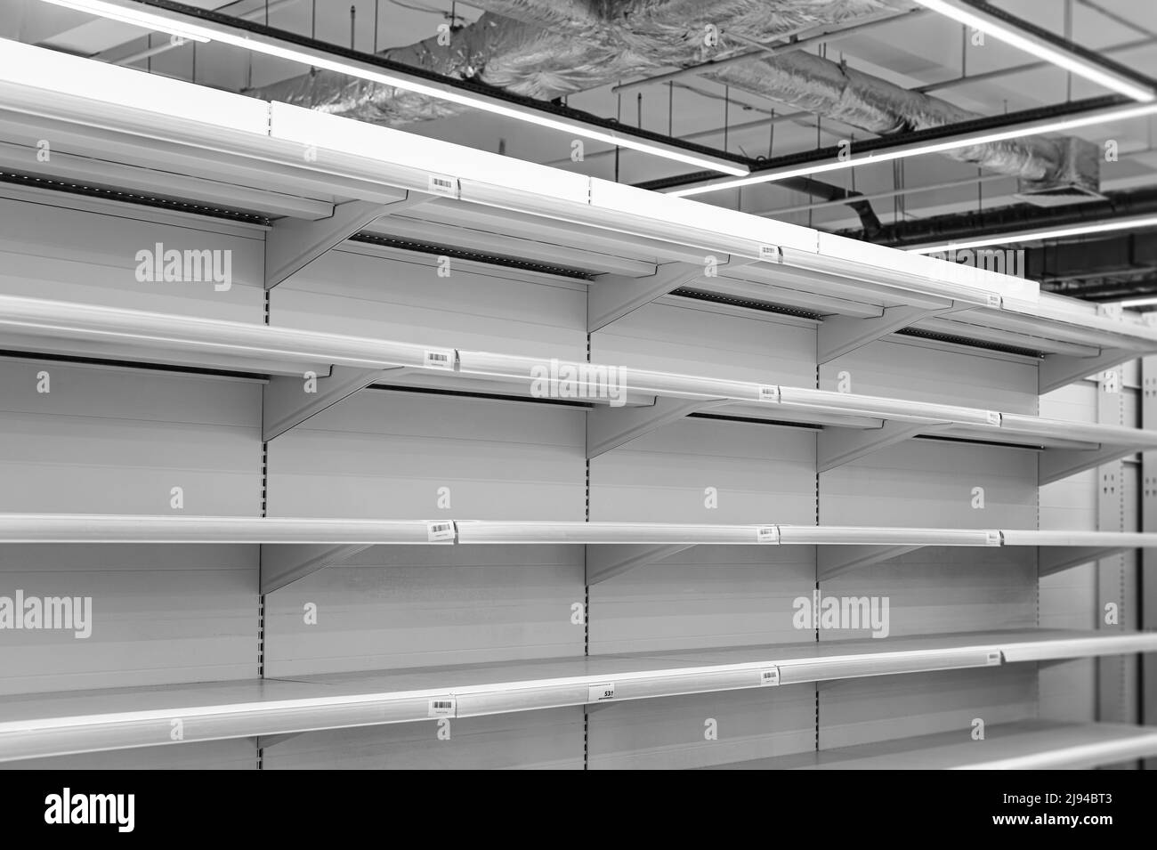 empty white shelves in supermarket Stock Photo