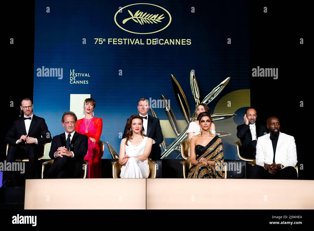 Joachim Trier (l-r), Rebecca Hall, Jeff Nichols, Asghar Farhadi, Vincent Lindon, Jasmine Trinca, Deepika Padukone, Ladj Ly on stage during the Opening Ceremony during the 75th Annual Cannes Film Festival at Palais des Festivals in Cannes, France, on 17 May 2022. Stock Photo