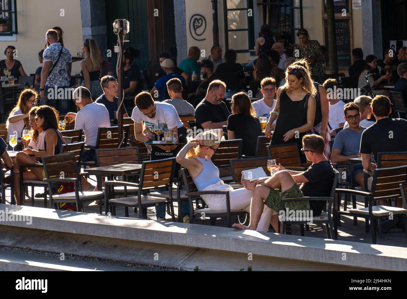Ljubljana, Slovenia - 07.15.2021: people are sitting at the street cafe in Ljubljana Stock Photo