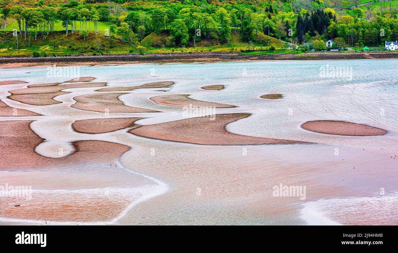 Wave scuptured ripples form colourful sand patterns on the beach  in Applecross Bay at low tide,  Applecross Peninsula,  Wester Ross, Scotland, Stock Photo