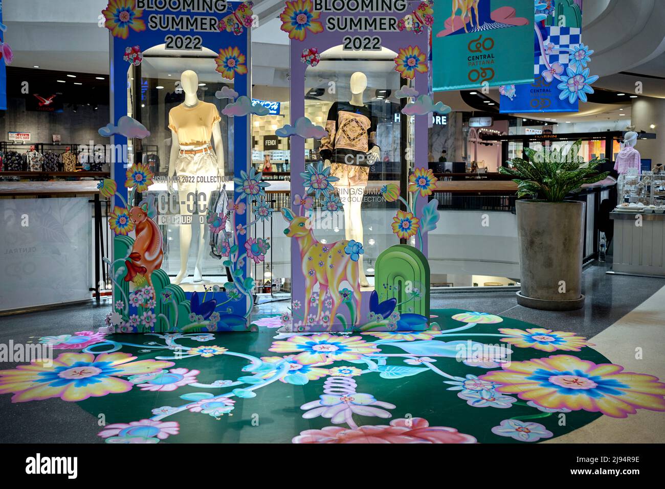 Summer clothes display promoting summertime wear with floor painted flower design of 'Blooming Summer' Thailand Southeast Asia Stock Photo