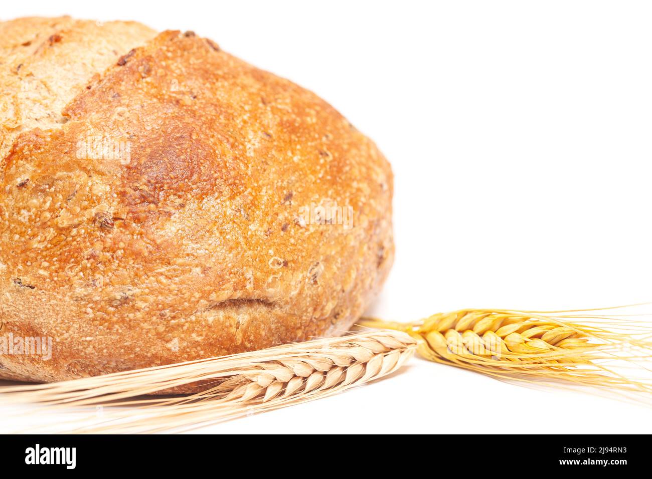 Loaf of round bread with wheat ears isolated on white background Stock ...