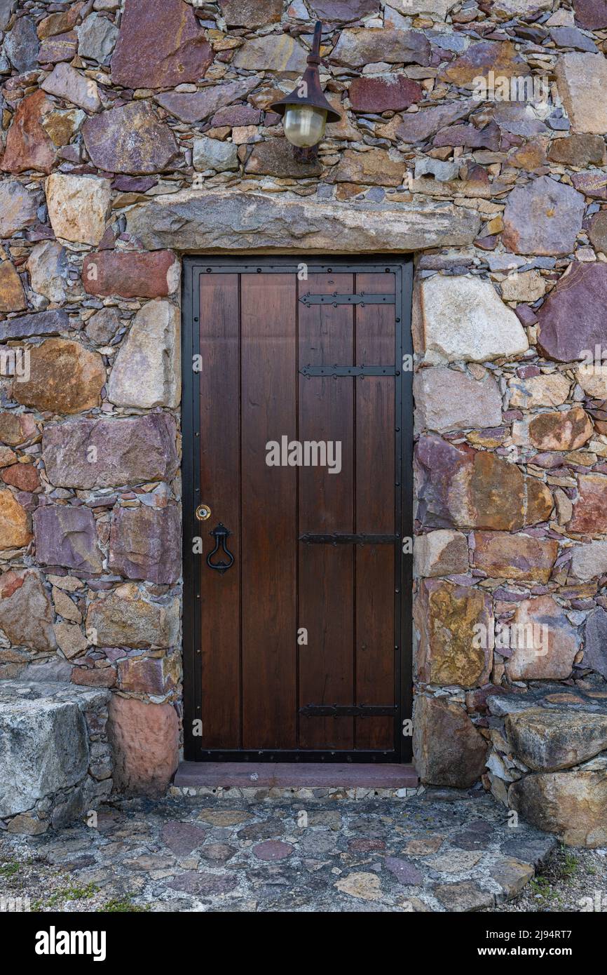 Ancient wooden door in stone wall Stock Photo - Alamy
