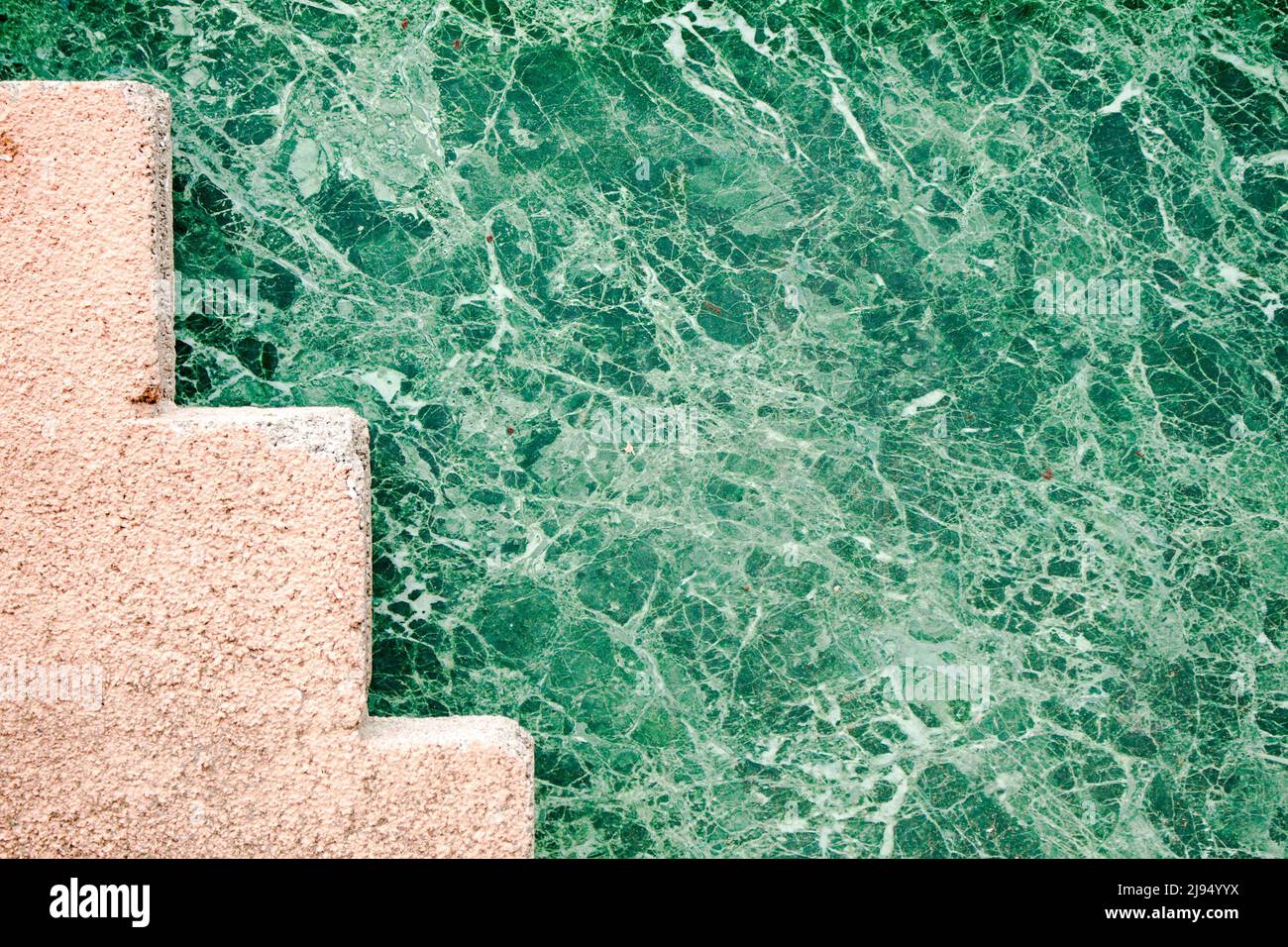 Zigzag shaped concrete structure painted in pink. Stock Photo