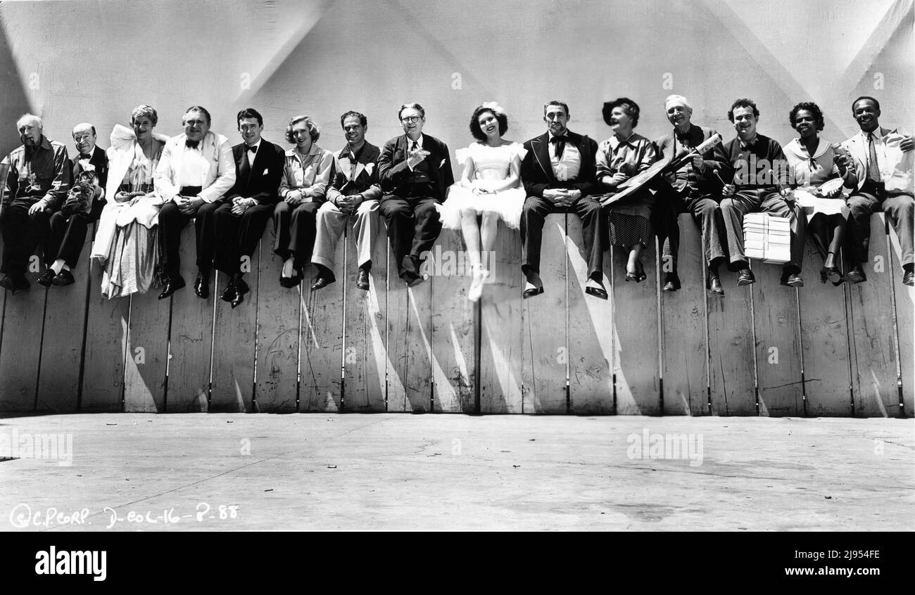 On Set Cast Photo with from left HALLIWELL HOBBES, DONALD MEEK , MARY FORBES, EDWARD ARNOLD, JAMES STEWART, JEAN ARTHUR, Director FRANK CAPRA, LIONEL BARRYMORE, ANN MILLER, MISCHA AUER, SPRING BYINGTON, SAMUEL S. HINDS, DUB TAYLOR, LILLIAN YARBO and EDDIE 'ROCHESTER' ANDERSON during filming of YOU CAN'T TAKE IT WITH YOU 1938 director FRANK CAPRA screenplay Robert Riskin based on the play by George S. Kaufman and Moss Hart music Dimitri Tiomkin Columbia Pictures Stock Photo