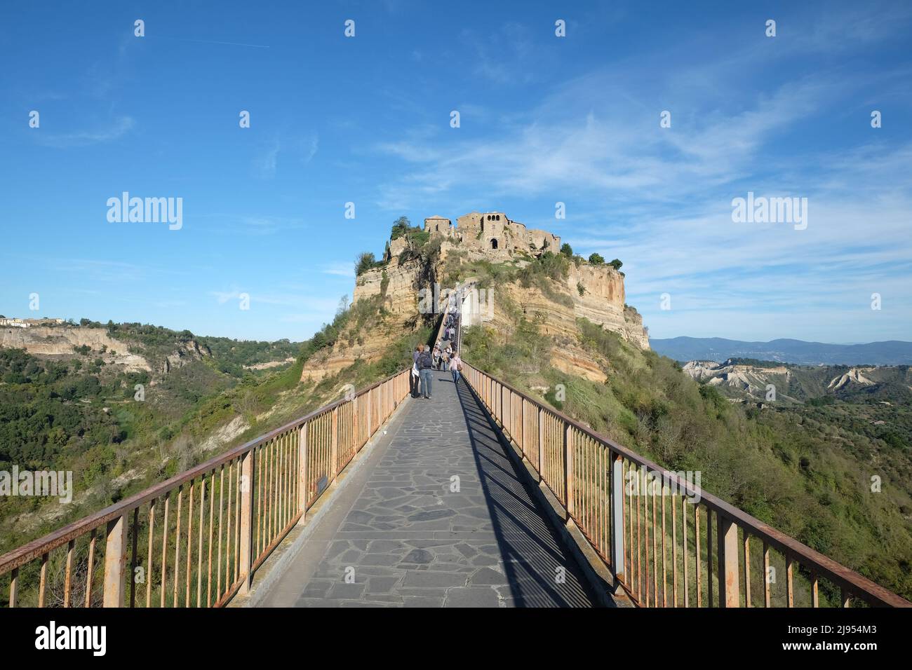 Tourists at the Civita di Bagnoregio, Lazio, Italy. Panoramic view of Medieval town on the mountain. Stock Photo