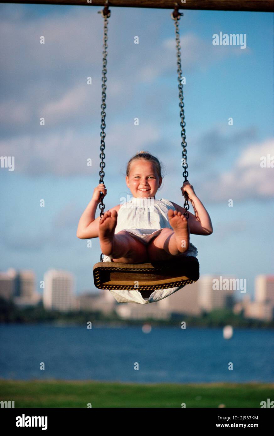 Australia. Riverside park. Children. Girl on a swing. Stock Photo