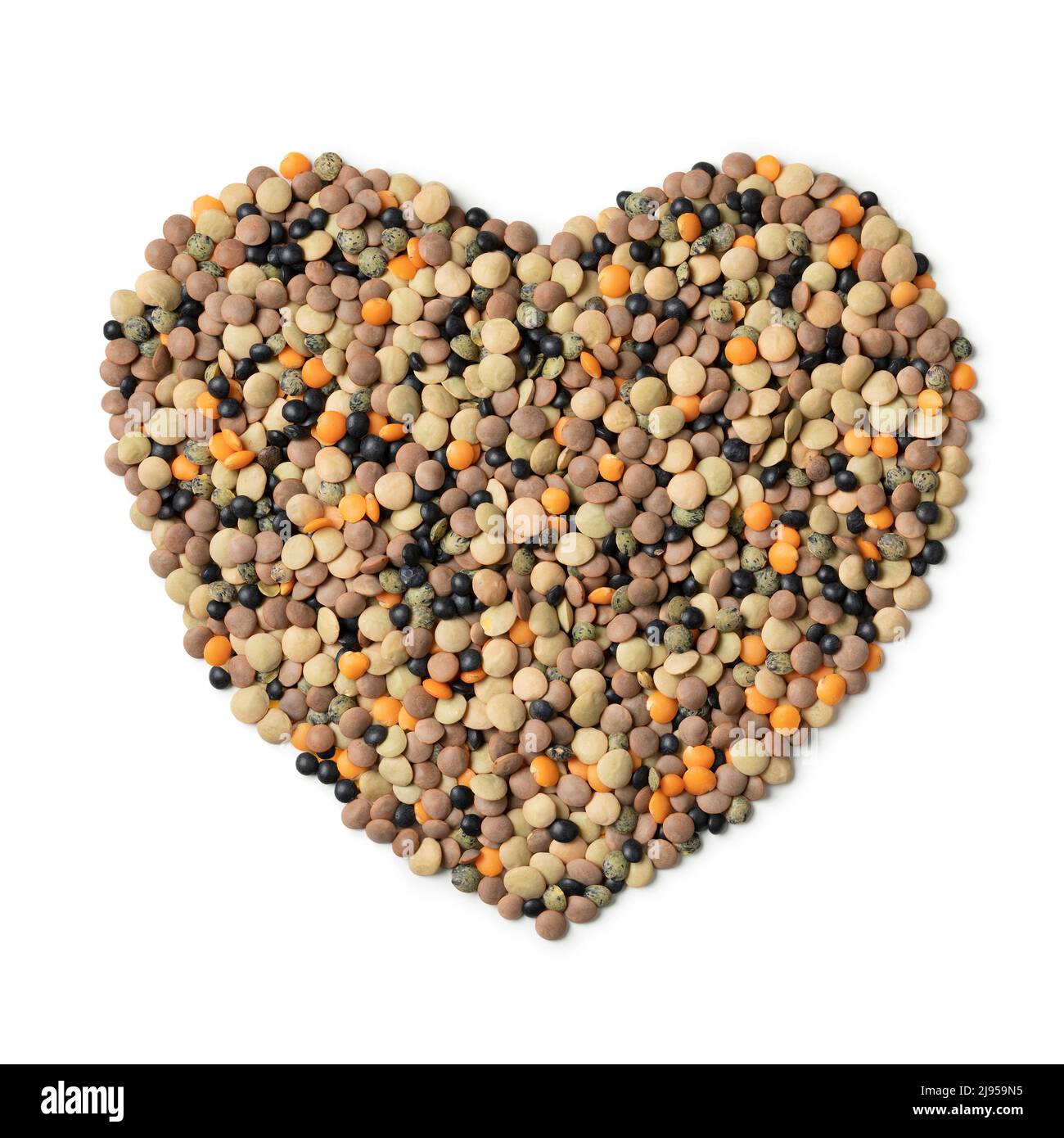 Mixture of different type lentils in heart shape isolated on white background Stock Photo