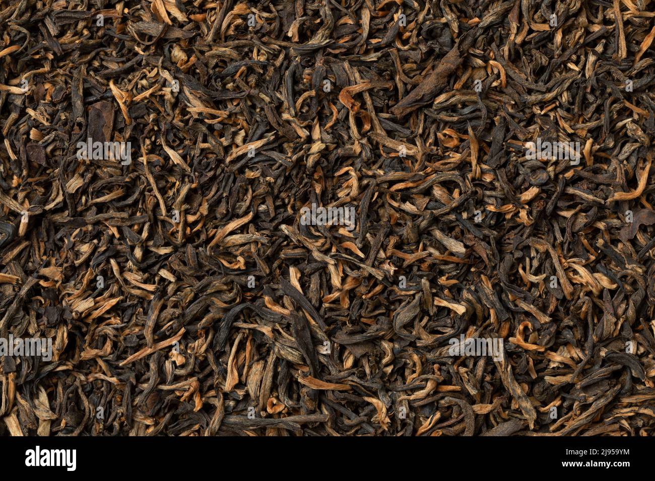 Dried Chinese Yunnan Mao Feng tea leaves close up full frame as background Stock Photo