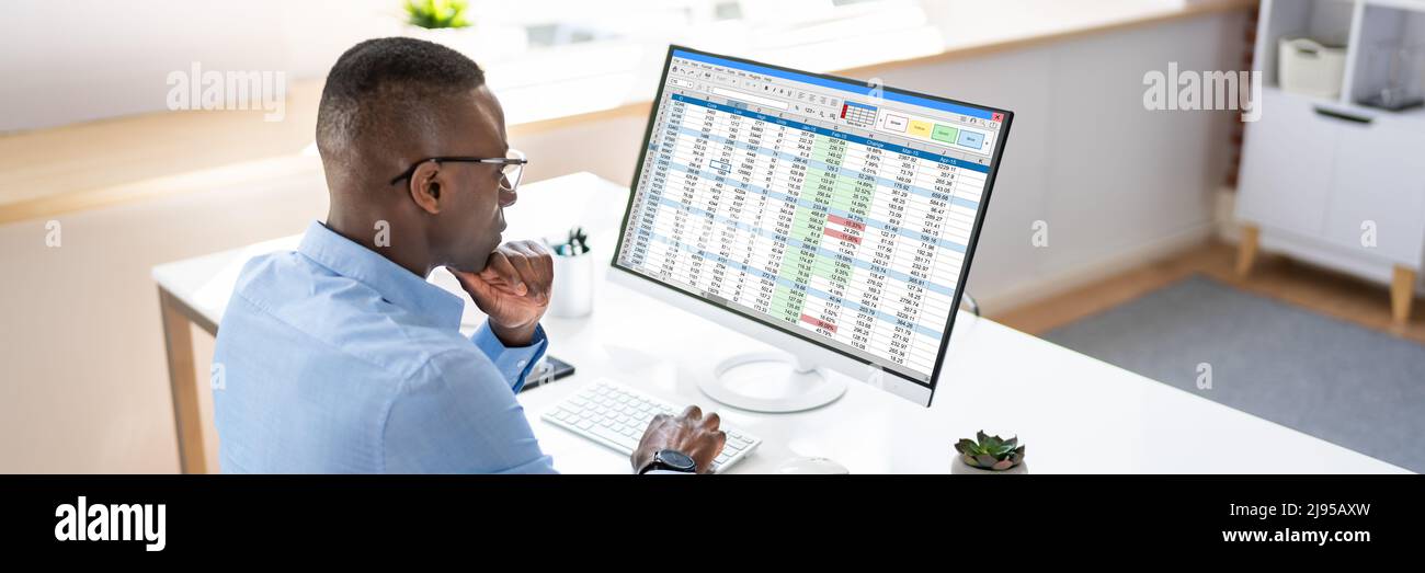 Analyst Employee Working With Spreadsheet On Computer Stock Photo