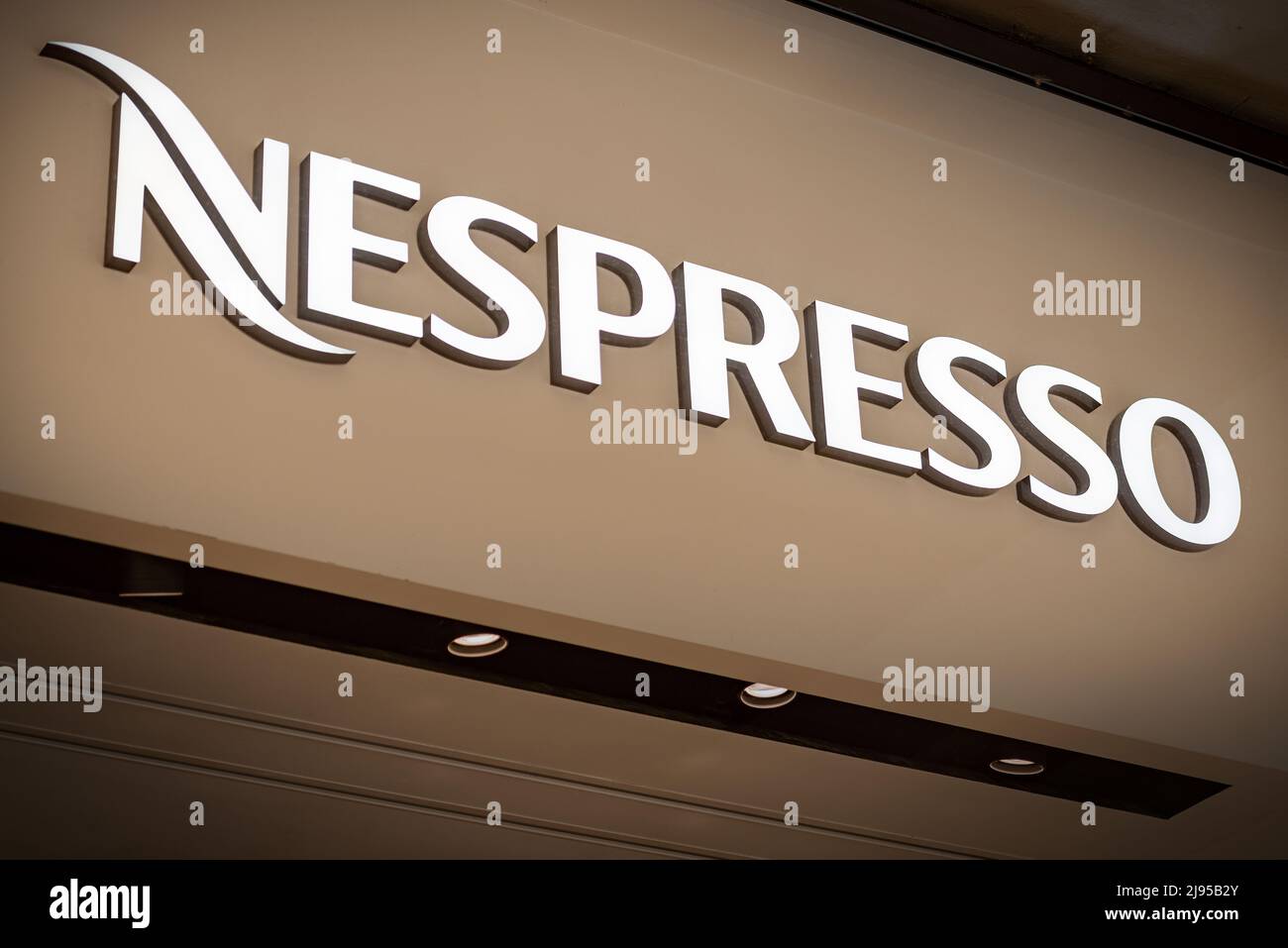 Close-up of the Nespresso corporate logo, a brand owned by the Swiss Nestle Group, above the shop window of a store in Treviso downtown. Veneto, Italy Stock Photo