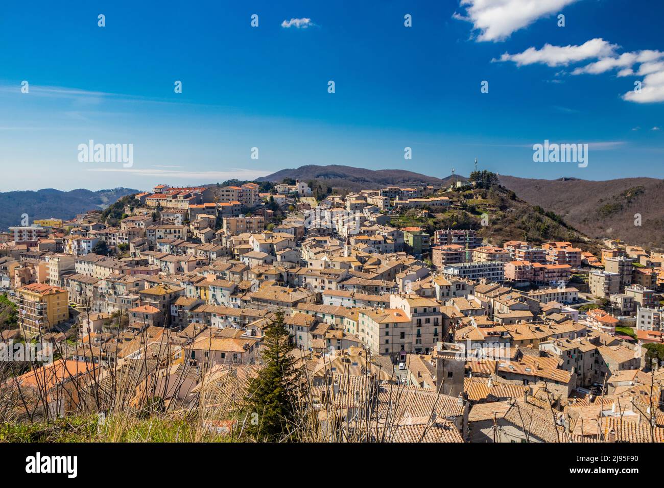 The small village of Tolfa, in Lazio. The view of the town perched on the mountain. Above, the church of the Capuchin monastery. The roofs of the hous Stock Photo