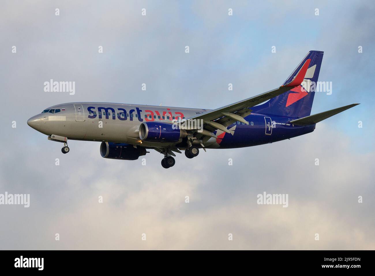 SAINT PETERSBURG, RUSSIA - OCTOBER 28, 2020: Airplane Boeing 737-700 (VQ-BBI) of Smartavia airline in cloudy sky. Profile view Stock Photo