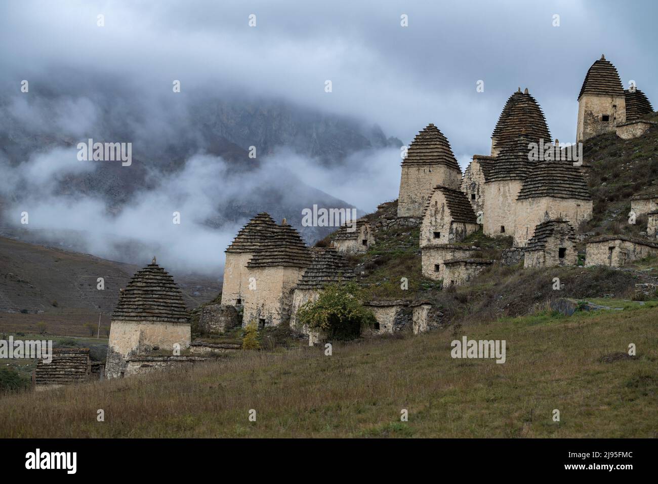 Ancient grave complex Dargavs on a foggy October day. Northern Ossetia-Alania, Russian Federation Stock Photo