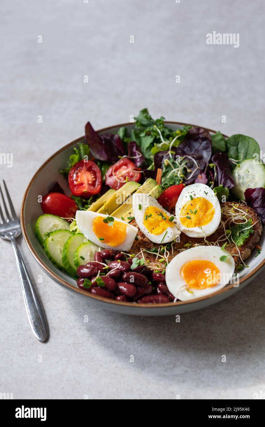 Medium boiled eggs with sasld, healthy breakfast Stock Photo