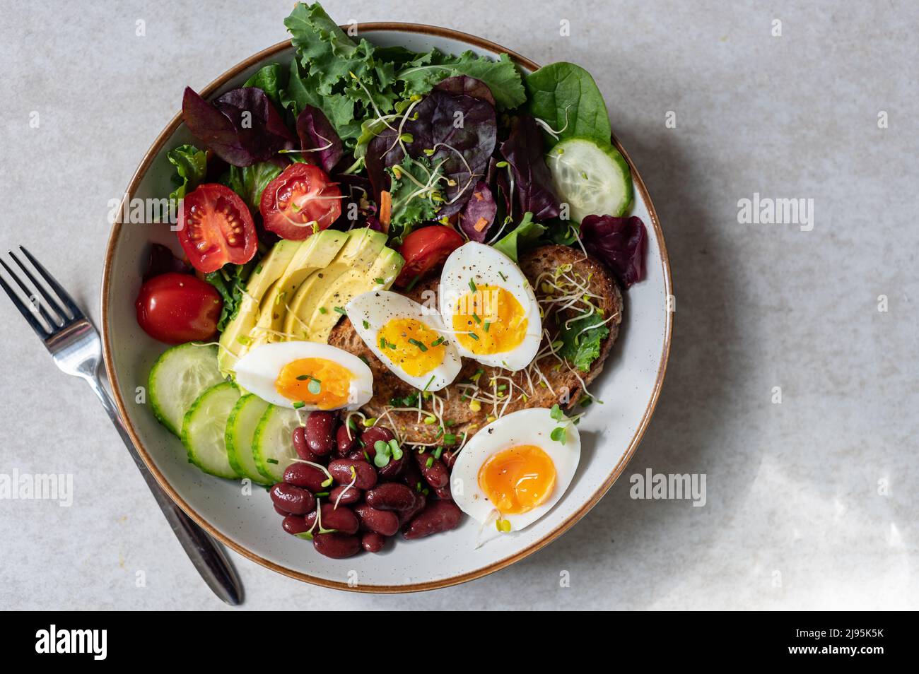 Medium boiled eggs with sasld, healthy breakfast Stock Photo