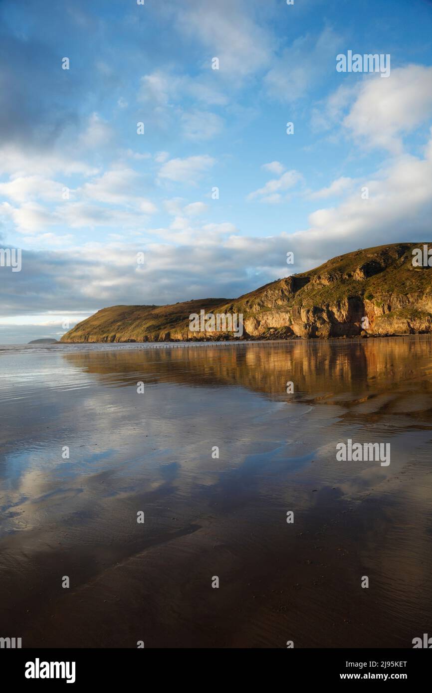 Bren Down reflected in the wet sand of Brean Beach. Somerset, UK. Stock Photo