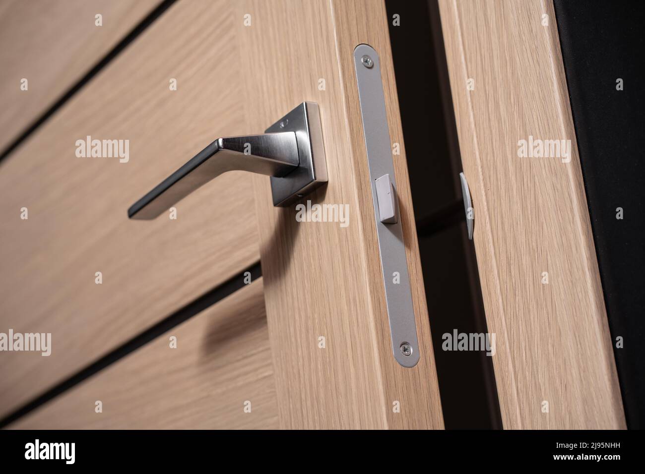 modern and secured metal door handle and latch detail Stock Photo Alamy