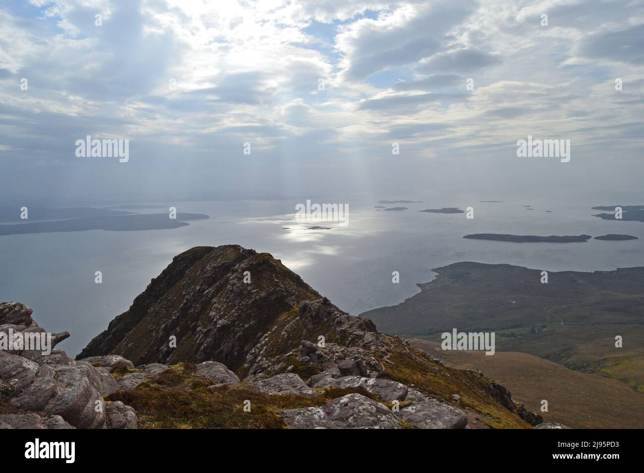 A peak of Ben Mor Coigach, a ridge near Ullapool, hikers, walkers, views of Summer Isles. Loch Broom in the background. NW Scotland, Assynt Stock Photo
