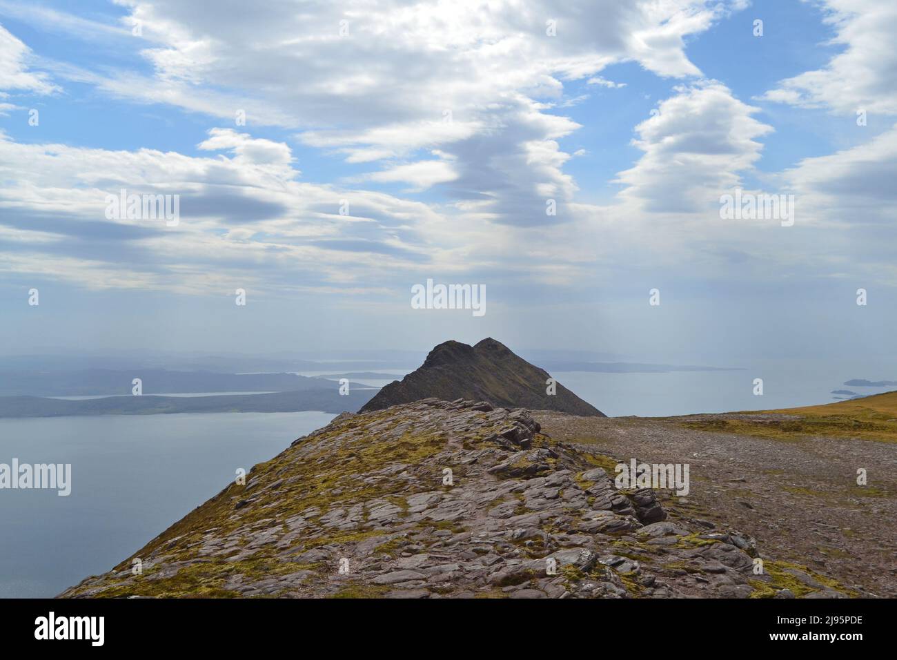 A peak of Ben Mor Coigach, a ridge near Ullapool, hikers, walkers, views of Summer Isles. Loch Broom in the background. NW Scotland, Assynt Stock Photo