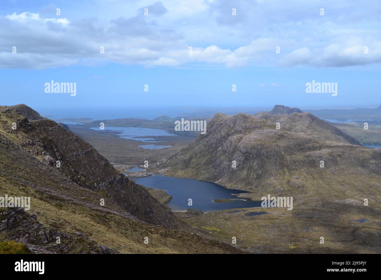 A view looking northwest from Ben Mor Coigach to Sgurr Fhidlheir (the Fiddler) and Stac Pollaidh across a lachlan. Loch Lurgain. Wild coastal scenery Stock Photo
