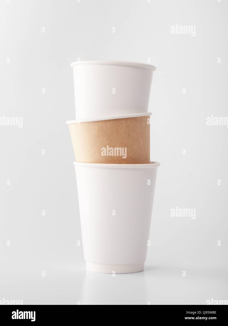 Three takeaway paper cups on white background. Stock Photo