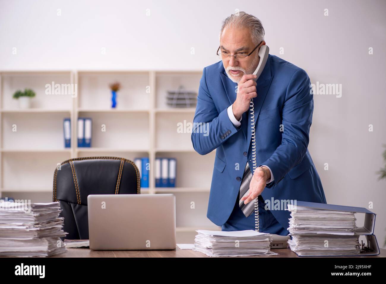 Old businessman employee working at workplace Stock Photo - Alamy