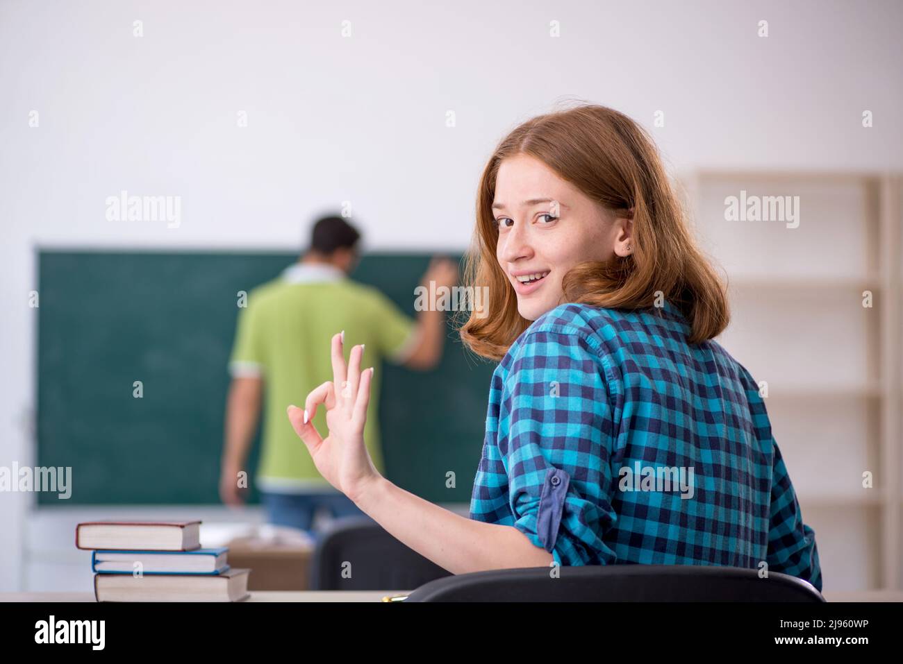 Young teacher teaching student in the classroom Stock Photo