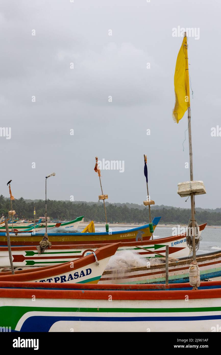 Colourful fishing boats lined on the sandy stretch of Wayari Bhutnath Beach in Malvan, Maharashtra, India Stock Photo