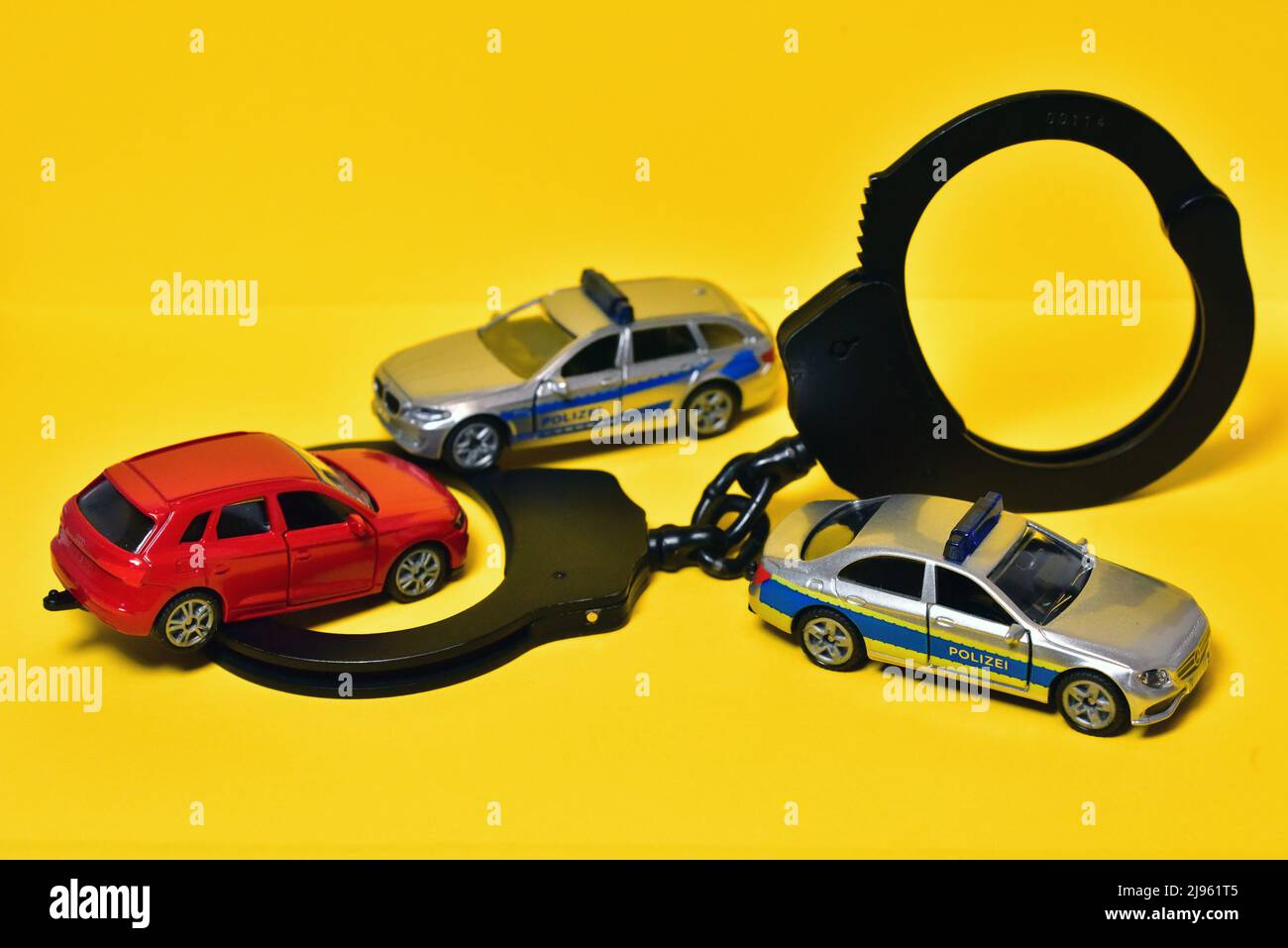 handcuffs with  toy police car Stock Photo