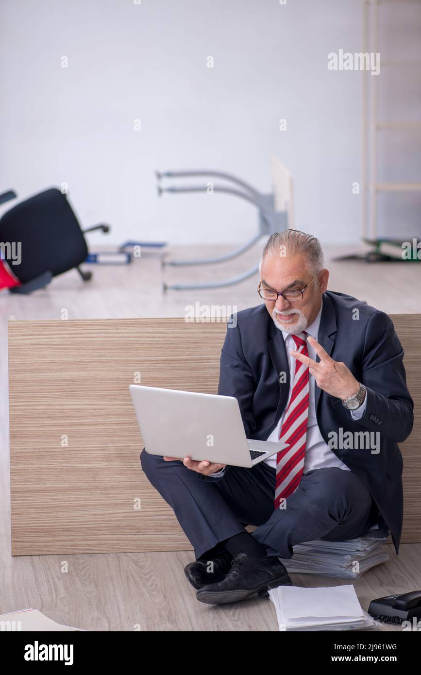 Old businessman employee working overtime at workplace Stock Photo - Alamy