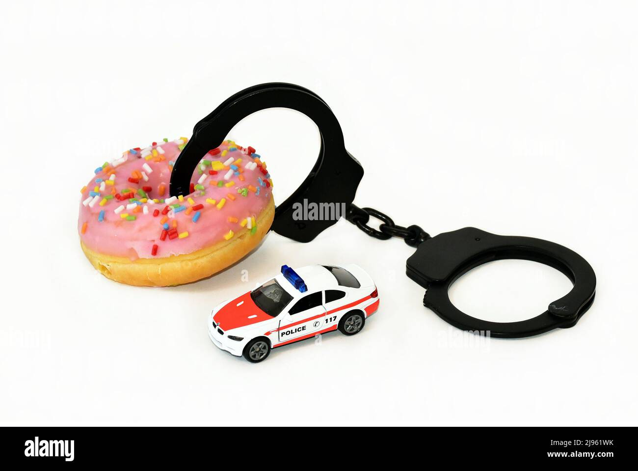 donut with handcuffs and police car Stock Photo