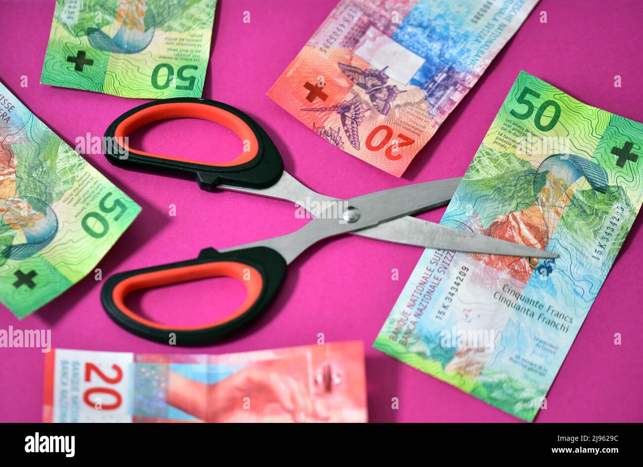 scissor with banknote from zwitserland Stock Photo Alamy