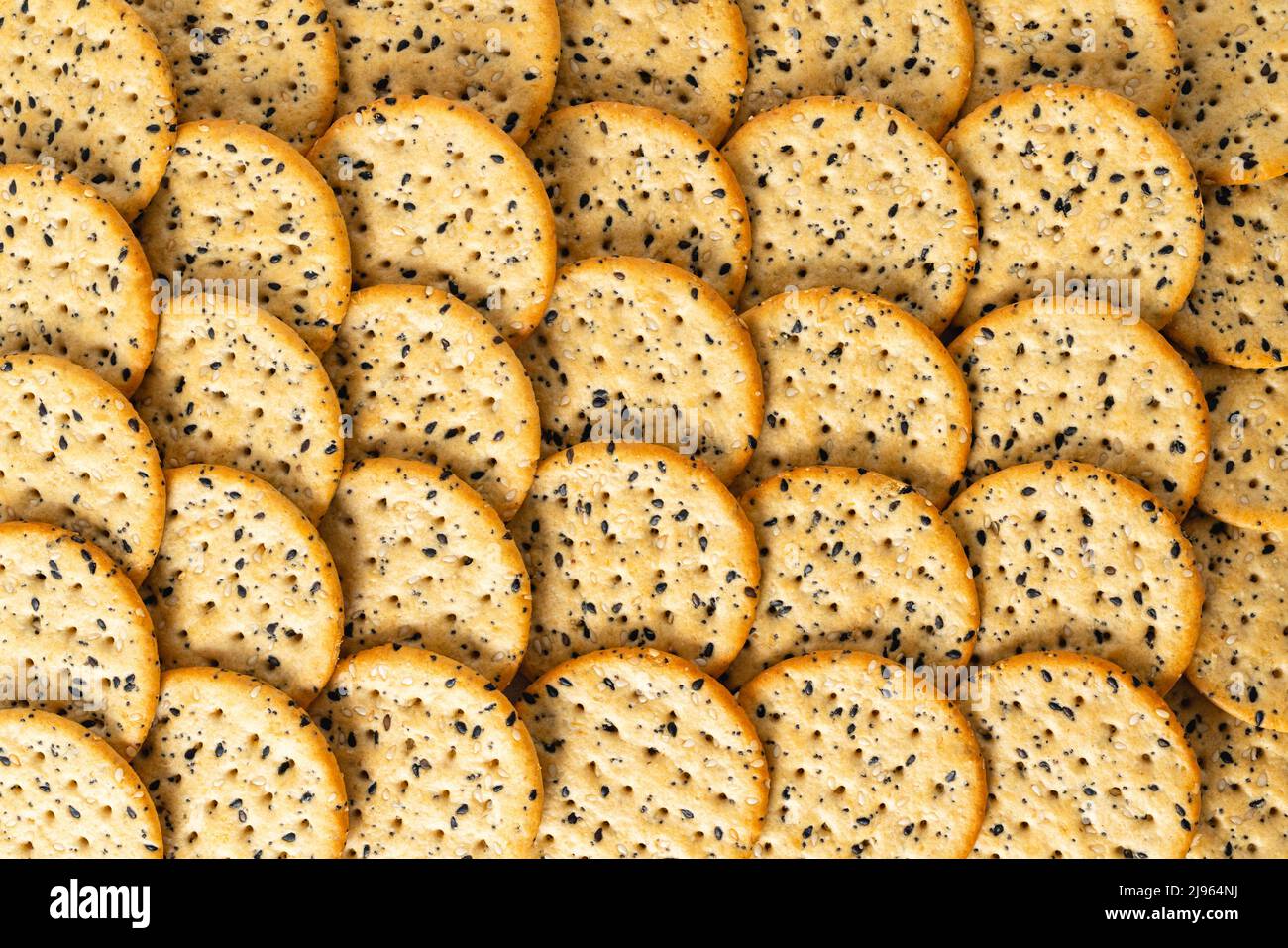Sesame and poppy seed crackers close up from above. Food background